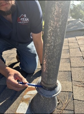 Plumbing vent pipe on a shingle roof with cracked, peeling sealant falling away from the collar boot.